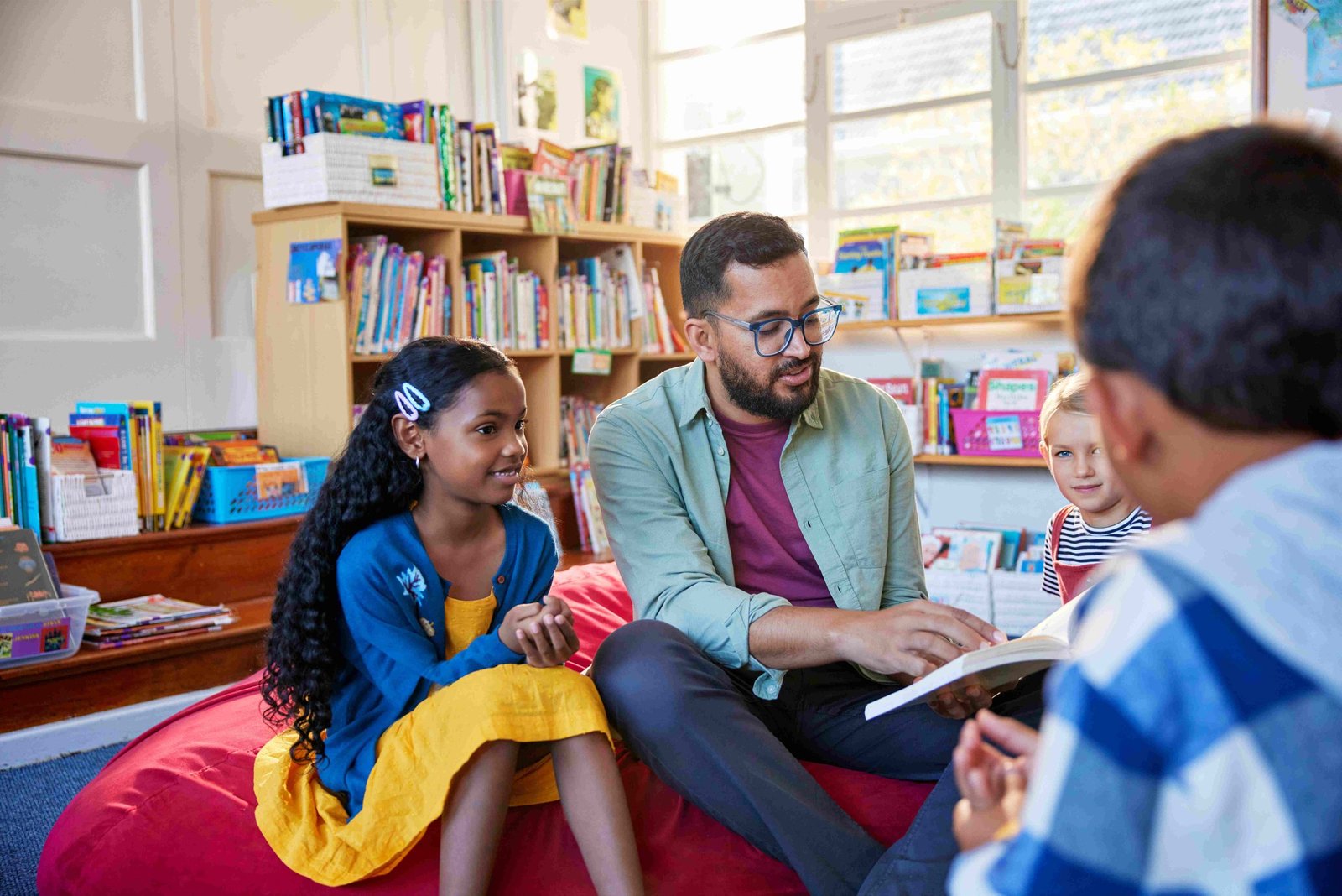 Image of a father reading a story as a volunteer at school.
