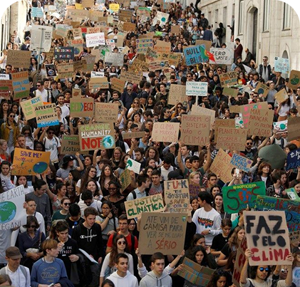 Large group of people with signs at a protest.