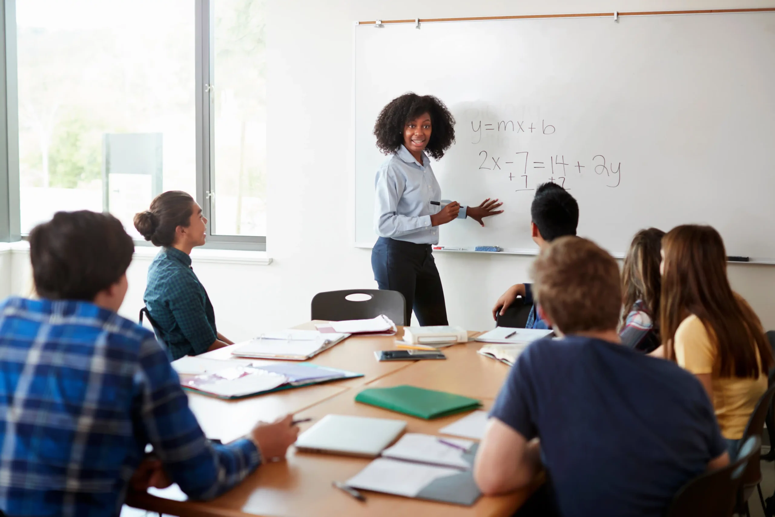 Teacher at whiteboard teaching math