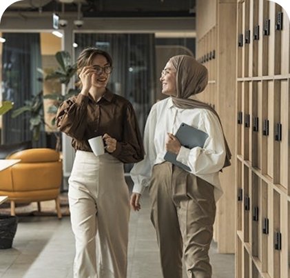 A woman with a headscarf talking to another woman.