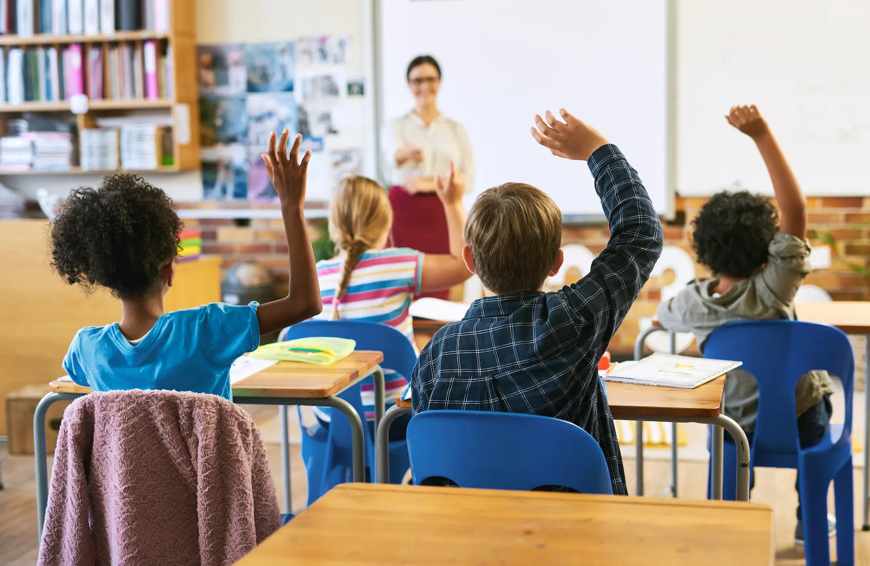 Education, question with group of children in classroom and raise their hands to answer.